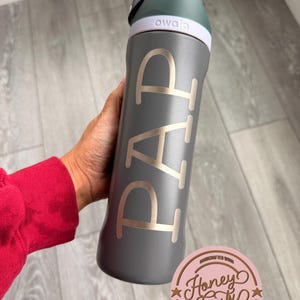 May include: A set of three ceramic mugs with a speckled, matte finish. The mugs are in shades of cream, light gray, and dark gray. Each mug has a simple, minimalist design, perfect for coffee or tea.