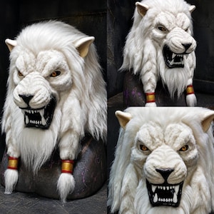 May include: A white lion mask featuring a textured faux fur mane, amber-coloured eyes, and a black open mouth with visible white teeth. The mask includes two braided sections of fur on the sides, each secured with a red and gold cylindrical band.