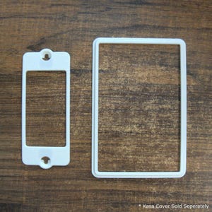 May include: Two white plastic light switch covers. One is rectangular with a single hole and the other is a rectangular frame. The text at the bottom reads "* Kasa Cover Sold Separately".