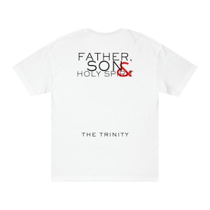 May include: White t-shirt with black text that reads "Father, Son, Holy Spirit" and "The Trinity". The word "Son" is in red.