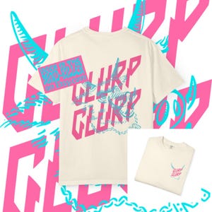 May include: Cream-colored t-shirt with a pink and blue graphic design. The design features the word "GLURP" in pink, with a blue illustration of a creature. The text "SAVE THE MINO-KINGS ON ETSY.COM" is also visible.