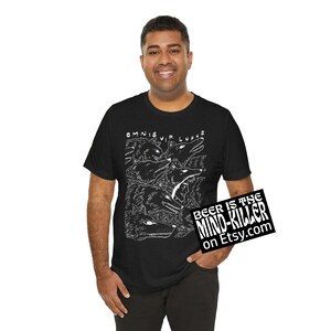 May include: Black t-shirt featuring a white illustration of wolves and the text "OMNIS VIR LUPUS". The shirt also has a small sign that says "BEER IS THE MIND-KILLER on Etsy.com".
