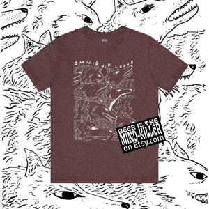 May include: Maroon t-shirt with a white illustration of wolves and the text "OMNIS VIR LUPUS." A small black square with white text that reads "BEER IS THE MIND-KILLER on Etsy.com" is on the bottom right.