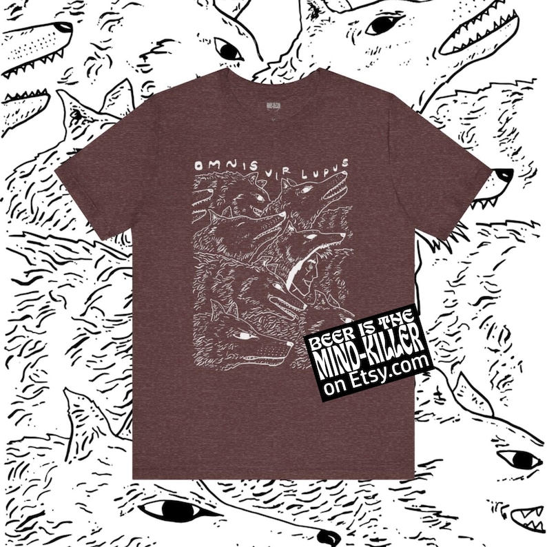 May include: Maroon t-shirt with a white illustration of wolves and the text "OMNIS VIR LUPUS." A small black square with white text that reads "BEER IS THE MIND-KILLER on Etsy.com" is on the bottom right.