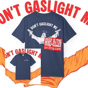 May include: Navy blue t-shirt with the text "DON'T GASLIGHT ME" and a graphic of a figure holding two guns. The phrase "BEER IS THE MIND-KILLER" is on a red rectangle with a website address.