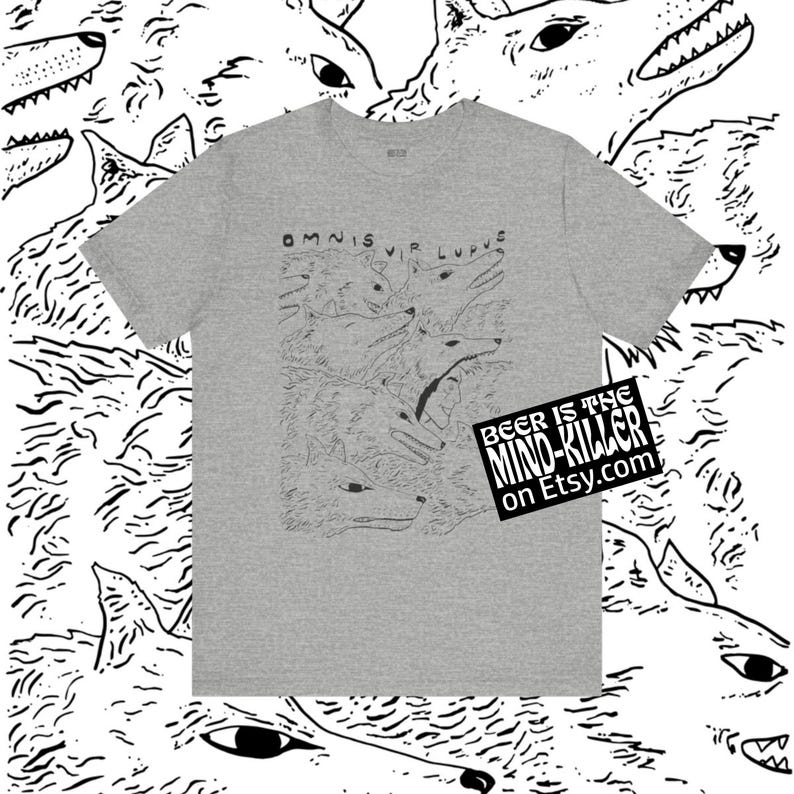 May include: A heather gray t-shirt featuring a black and white illustration of wolves with the text "OMNIS VIR LUPUS". The shirt also has a sticker that says "BEER IS THE MIND-KILLER on Etsy.com".
