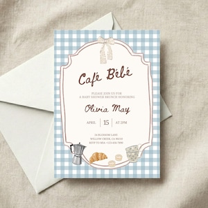 May include: Baby shower brunch invitation with a blue gingham background. The invitation features the text "Café Bébé" and details for Olivia May's baby shower, including the date, time, and location. A white envelope is in the background.