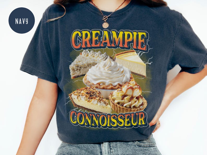 May include: A navy blue t-shirt with a graphic of various cream pies and the text "CREAMPIE CONNOISSEUR".