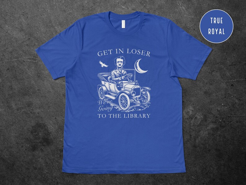 May include: A royal blue t-shirt with a white graphic of a man driving a vintage car with the text "Get in loser, we're going to the library".