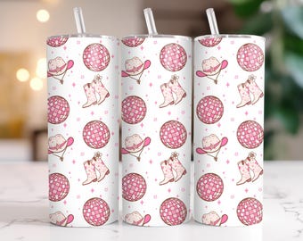 May include: Three pink and white tumbler cups with a pattern of pink disco balls, cowboy hats, and boots. The cups have lids and straws.