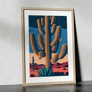May include: A framed illustration of a large saguaro cactus in a desert landscape under a starry night sky. The cactus is brown and green with a textured surface. The background is a blue sky with white stars and a red and orange desert landscape.