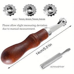 May include: A leather stitching groover tool with a dark brown wooden handle, a metal head, and three interchangeable serrated wheels in sizes 3mm, 4mm, 5mm, and 6mm. The tool measures 14cm in length and includes a small metal screwdriver.