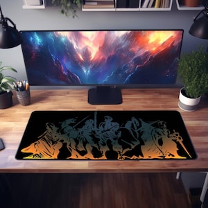 May include: A black gaming mouse pad with a colorful silhouette of a group of characters from a video game. The characters are in a gradient of orange, yellow, and green.