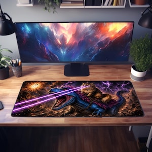 May include: A rectangular desk mat featuring a vibrant graphic print of a fluffy brown cat riding a blue and purple dinosaur. The dinosaur has its mouth open, emitting two bright pink laser beams against a dark, stormy, and cosmic background.