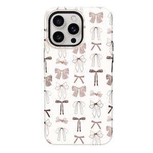 May include: White phone case with a pattern of brown and pink bows.