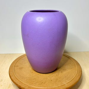 May include: A set of three ceramic mugs with a speckled, matte finish. The mugs are in shades of cream, light gray, and dark gray. Each mug has a simple, minimalist design and a rounded handle.