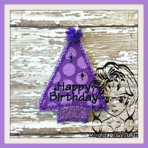 May include: Purple felt birthday hat with white polka dots and a fluffy pom pom on top. The hat has the words "Happy Birthday" embroidered on it.
