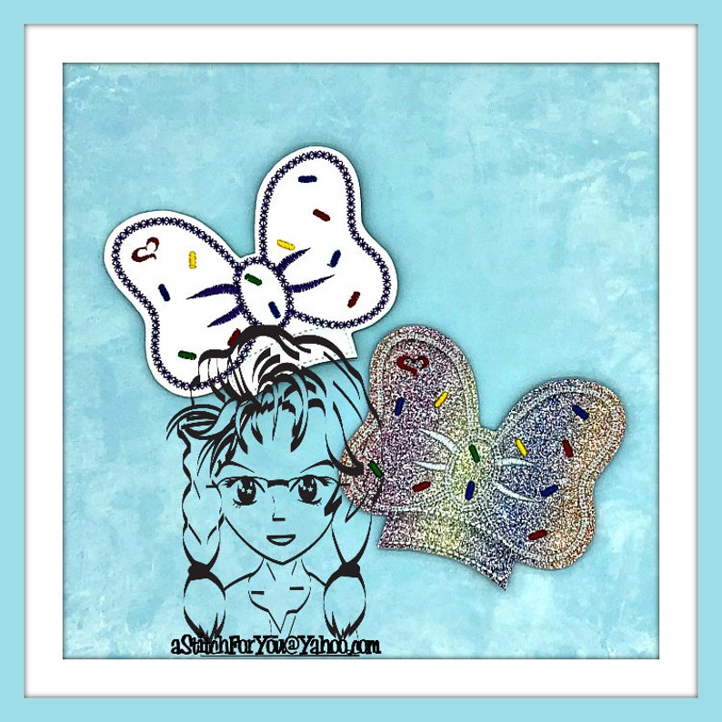 May include: A digital illustration of a girl with a blue bow in her hair. The bow is decorated with white and colorful sprinkles. The girl is wearing a blue shirt and has a blue background. The text "aStitchForYou@Yahoo.com" is at the bottom of the image.