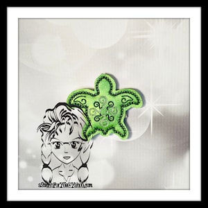 May include: A black and white cartoon illustration of a girl with long hair wearing glasses. A green embroidered turtle with a floral design is behind her head. The text "aStitchForYou@Yahoo.com" is at the bottom of the image.