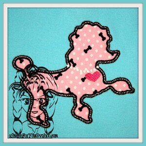 May include: Pink fabric poodle applique with white polka dots and black bone-shaped stitching. The poodle has a pink heart on its chest. The applique is sewn onto a light blue fabric background.