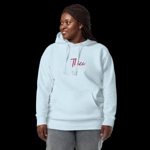May include: A light blue hooded sweatshirt with the word "Thicc" printed in red on the front.