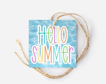 May include: A square gift tag with the words "HELLO SUMMER" in colorful letters against a blue water background. The tag is attached to a natural twine string, perfect for summer-themed gifts or decorations.
