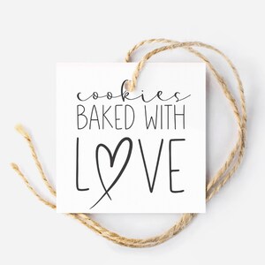 May include: A white gift tag with black text that reads "cookies baked with love" with a heart drawn around the word "love". The tag is tied with twine.