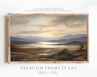 May include: A framed landscape painting depicting a lake surrounded by mountains and a cloudy sky at sunset. The painting is in a light wood frame. The text "PREMIUM FRAME TV ART 3840 x 2160" is below the painting.