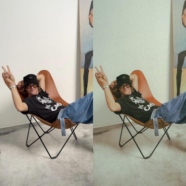 K&ouml;nnte beinhalten: Eine Person in einem schwarzen T-Shirt mit einem wei&szlig;en Aufdruck, einer schwarzen M&uuml;tze und blauen Jeans sitzt in einem braunen Ledersessel mit schwarzen Metallbeinen. Die Person macht mit der rechten Hand ein Peace-Zeichen.