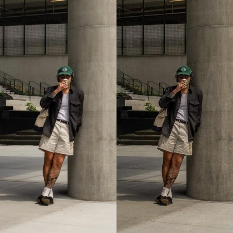 May include: A person wearing a black button-down shirt, beige shorts, and a green baseball cap. They are holding a white cup and standing next to a concrete pillar.
