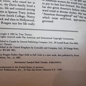 May include: A printed page with text from a book. The text includes copyright information, publication details, and the title "Nancy Reagan Fashion Paper Dolls in Full Color." The text is in black font on a white background.