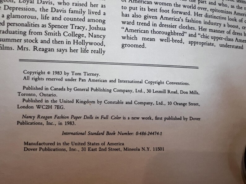 May include: A printed page with text from a book. The text includes copyright information, publication details, and the title "Nancy Reagan Fashion Paper Dolls in Full Color." The text is in black font on a white background.