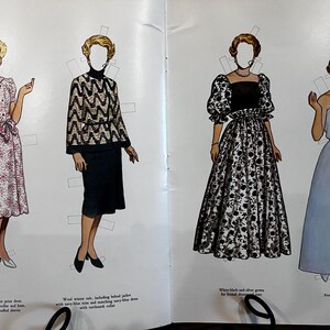 May include: Vintage paper dolls featuring four different outfits. The first is a red and white print dress with a scalloped collar and hem. The second is a wool winter suit with a black and gold patterned jacket. The third is a white and black floral gown. The fourth is a formal blue gown.