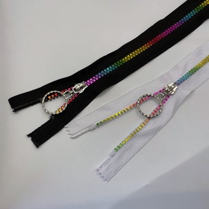May include: Two zipper pulls with rainbow coloured beads. One zipper pull is black and the other is white.