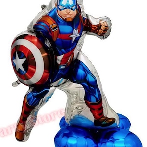 May include: A Captain America foil balloon in a dynamic pose, holding his shield. The balloon features a detailed illustration of the superhero in his iconic red, white, and blue costume. The base is a cluster of blue balloons.