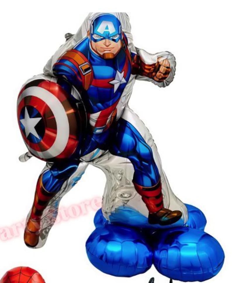May include: A Captain America foil balloon in a dynamic pose, holding his shield. The balloon features a detailed illustration of the superhero in his iconic red, white, and blue costume. The base is a cluster of blue balloons.