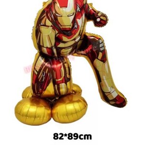 K&ouml;nnte beinhalten: Ein gro&szlig;er Iron Man Folienballon in Gold, Rot und Gelb, in einer hockenden Pose. Der Ballon misst ca. 82 x 89 cm und zeigt das Helm- und R&uuml;stungsdesign der Figur. Die Basis des Ballons ist goldfarben.