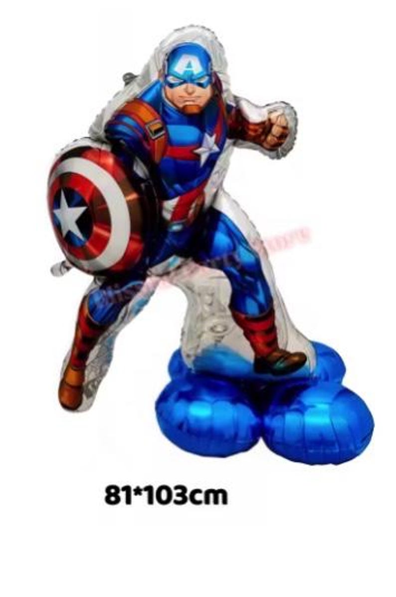 May include: Captain America balloon in a dynamic pose, holding his shield. The balloon is primarily blue, red, and white, with the dimensions of 81x103cm. The balloon is standing on a blue base.