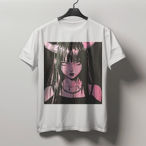 May include: White t-shirt featuring a pink and black anime-style illustration of a woman with long black hair, horns, and a necklace. The graphic has a dark, gothic aesthetic.