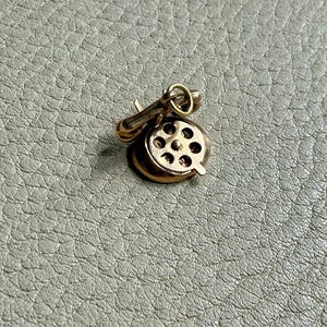 The 14k Gold Vintage Articulated Rotary Phone charm or pendant