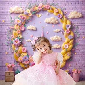 May include: A young girl wearing a pink sequined dress sits in front of a purple brick wall backdrop. The backdrop features a yellow braid with flowers and clouds, and a castle in the distance.