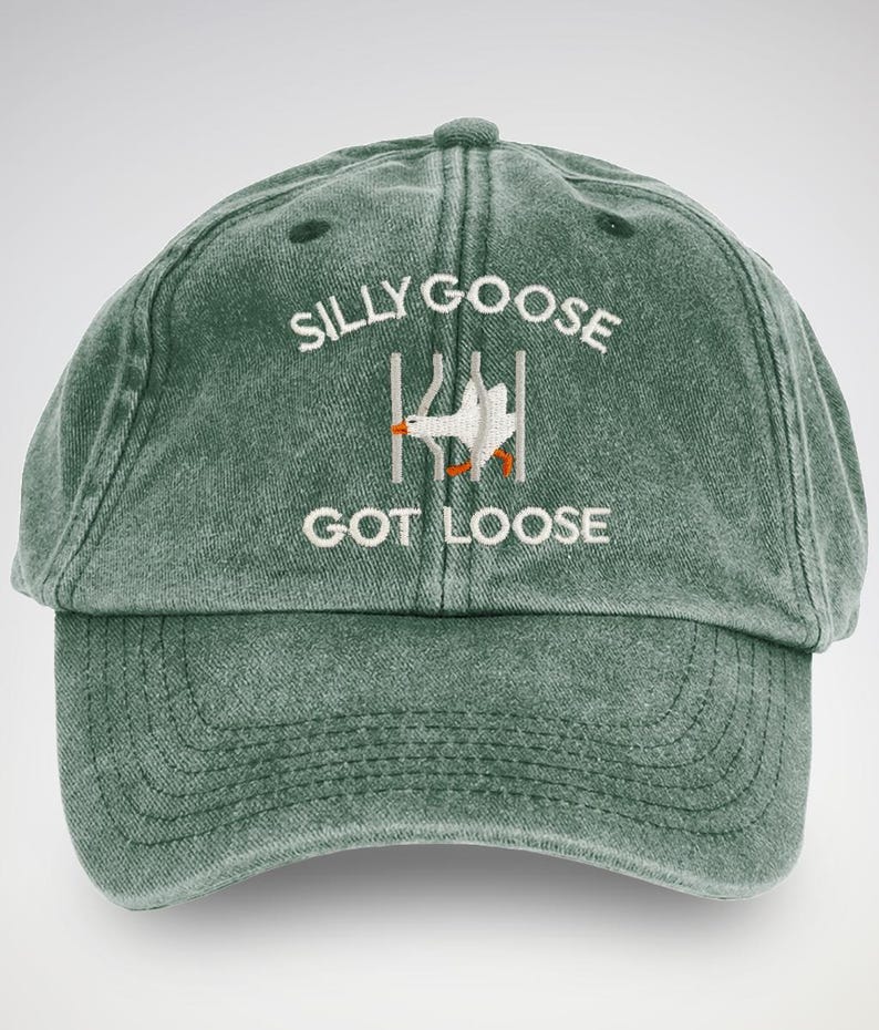 A playful embroidered cap featuring a cartoonish goose escaping from jail, adding a touch of humour to casual attire.