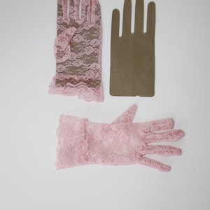 May include: Two pairs of pink lace gloves. One pair is short and the other is long.