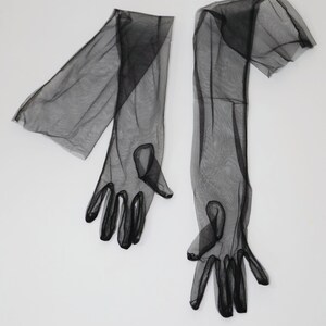 May include: A pair of long black sheer gloves with fingerless tips.