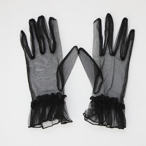 May include: A pair of black sheer gloves with ruffled cuffs.
