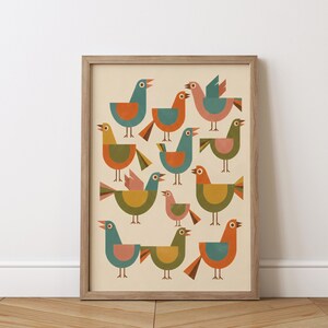 May include: A framed art print featuring a collection of stylized birds in various poses. The birds are rendered in a geometric style with a palette of teal, orange, yellow, and pink against a cream background. The frame is made of light brown wood.
