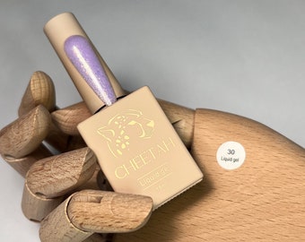 May include: A small bottle of light purple liquid gel nail polish with a cheetah print label. The label says "CHEETAH Liquid gel 7.5ml" and has a number "30" on a white circle with the words "Liquid gel".