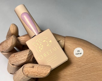 May include: A small bottle of clear liquid gel nail polish with a pink shimmer. The bottle is labelled "CHEETAH Liquid gel 15ml" and has a sticker that says "25 Liquid gel".