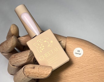 May include: A small bottle of light pink liquid gel nail polish with a cheetah print label. The label says "CHEETAH Liquid gel 15ml" and has a sticker that says "05 Liquid gel".