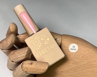 May include: A small bottle of light pink liquid gel nail polish with a cheetah print label. The label says "CHEETAH Liquid gel 15ml" and has a number "18" on a white circle with the words "Liquid gel".